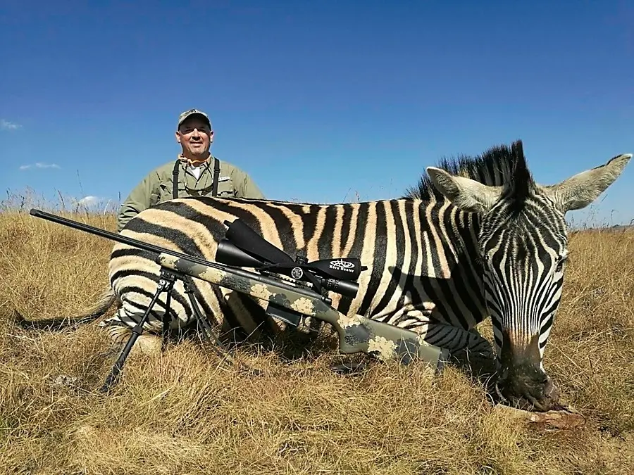 Safari hunting - Hunter with a Zebra trophy.