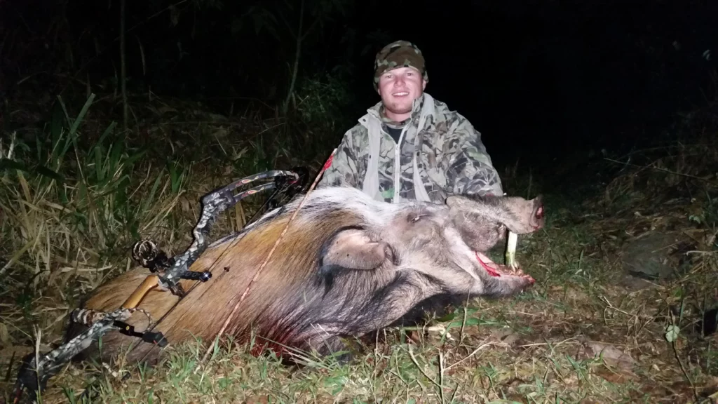 Bow hunter and trophy Bushpig taken after dark.