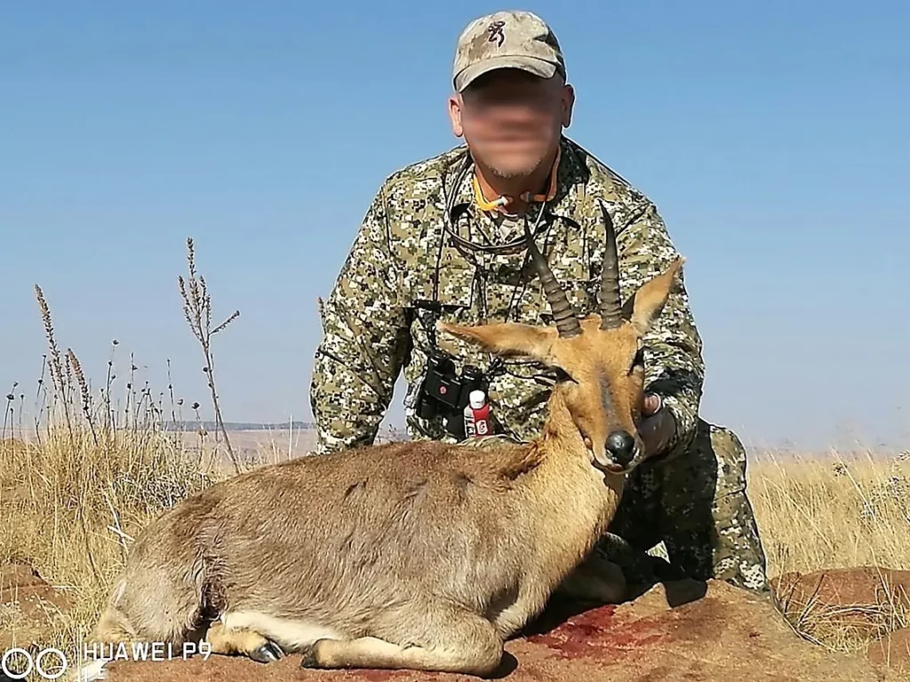 A successful Mountain Reedbuck hunt - hunter with a trophy mountain Reedbuck.