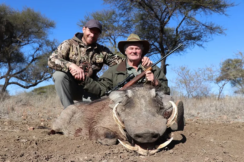 Price for Warthog hunting in South Africa - Hunters with a trophy Warthog boar.